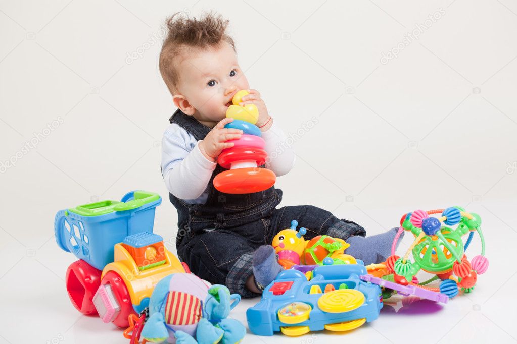 baby playing with toys white background