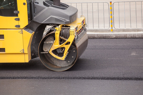 Heavy Vibration roller compactor at asphalt pavement works for road repairing