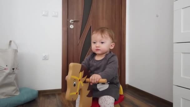 Glückliches Kleines Mädchen Das Auf Einem Schaukelpferd Aus Holz Spielt — Stockvideo