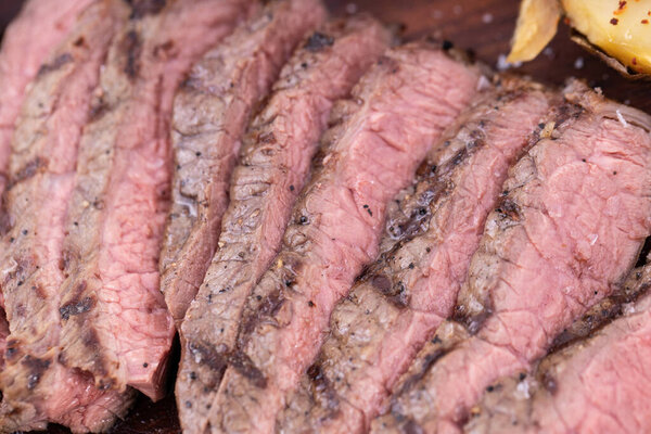 Close up sliced steak. Delicious steak on wooden board.