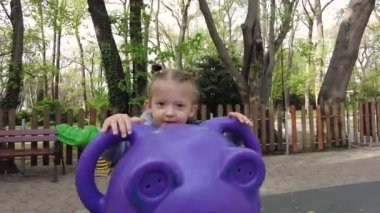 Küçük kız dışarıda oyun alanında eğleniyor. Mutlu çocukluk kavramı, olumlu duygular
