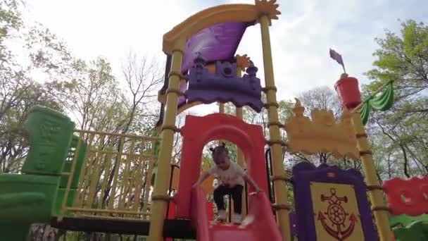 Little Girl Having Fun Playground Happy Girl Slides Plastic Slide — Stockvideo