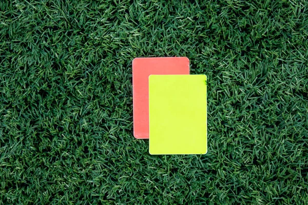 足球比赛 绿草红牌和黄牌 给裁判两张罚单 — 图库照片