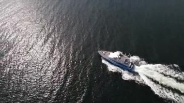 Ariel view of coast guard powerboat cruising in high speed. Speedboat border guard patrol the sea.