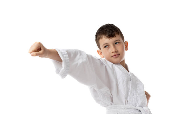 Boy in fighting position in white kimono, isolated on white