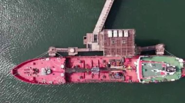 Red tanker ship loading and unloading oil and gas storage at industrial dock port, Business import export petrol and chemical by tanker ship