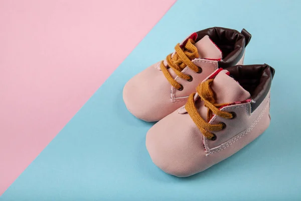 青とピンクの背景にピンクの赤ちゃんの靴 子供の背景の概念のためのファッション — ストック写真