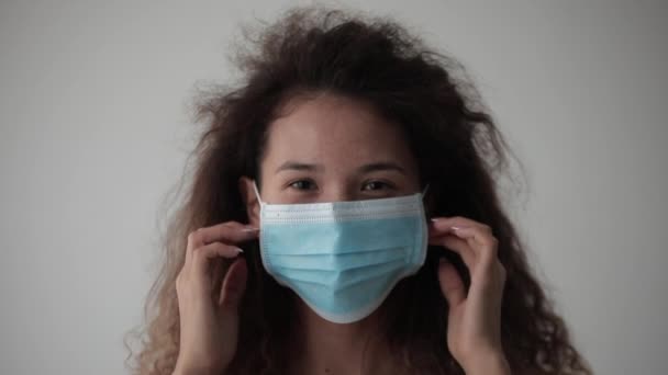 Beautiful Woman Thick Curly Hair Takes Medical Mask Her Face — Stock Video