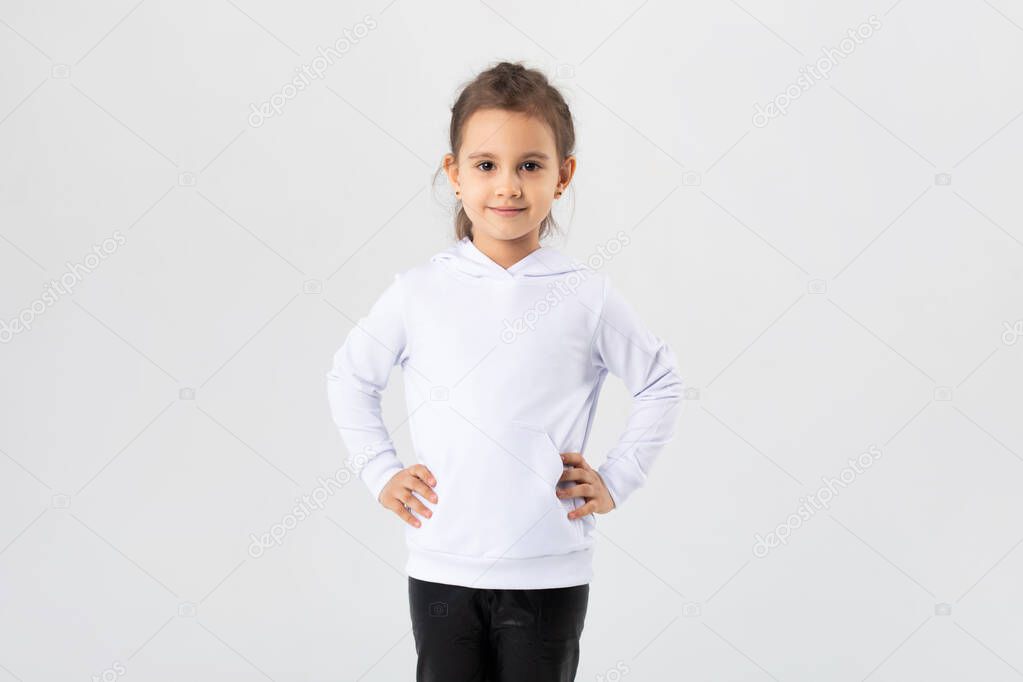 Girl in a white hoodie. Kids hoodies mockup.