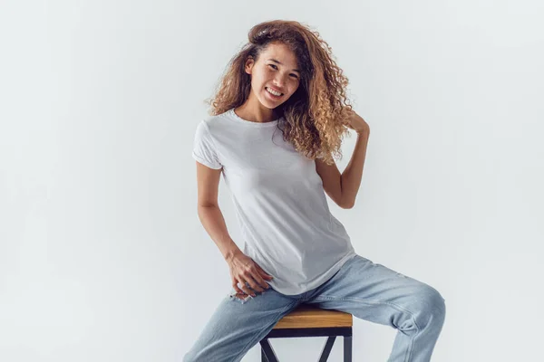 Mujer Sonriente Con Pelo Rizado Exuberante Blanco Camiseta Blanco Sienta —  Fotos de Stock