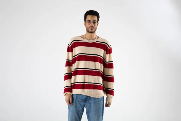 Young African American Man Eyeglasses Striped Sweater Stands White Background — Stock Photo, Image