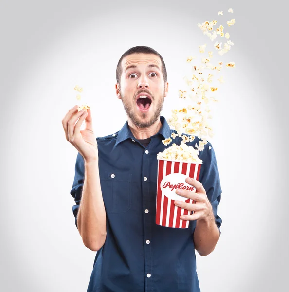 Young man watching a movie with popcorn — Stock Photo, Image