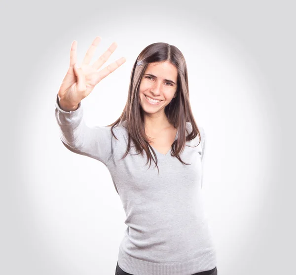 Ung kvinna visar fyra fingrar — Stockfoto