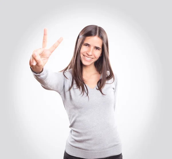 Mujer joven mostrando dos dedos Fotos De Stock Sin Royalties Gratis