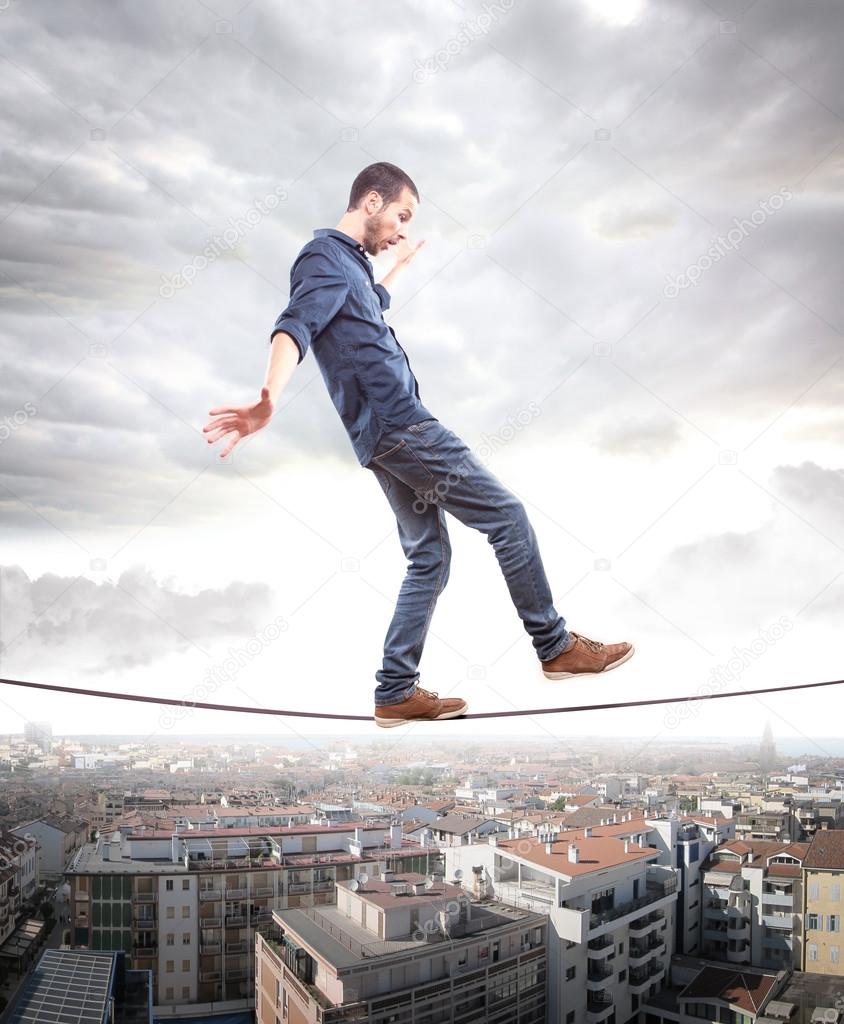Young man walking on a rope in balance