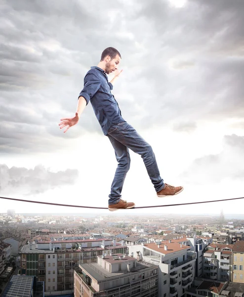 Young man walking on a rope in balance — Stock Photo, Image