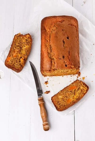 Pumpkin bread loaf over white wooden background