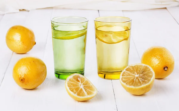 Organic lemons and lemonade over white background — Stock Photo, Image