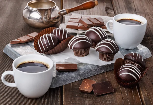 Chocolate muffins on dark wooden background — Stock Photo, Image