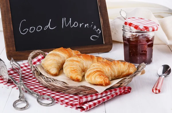 Breakfast with croissants and jam over white wooden background — Stock Photo, Image