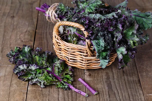 Bunch of kale on a wooden background — Stock Photo, Image