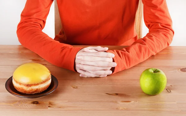Choosing between doughnut and apple — Stock Photo, Image