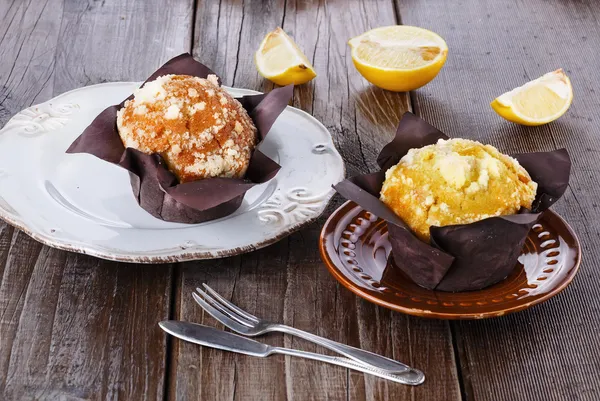 Lemon flavoured muffins on dark wooden background — Stock Photo, Image