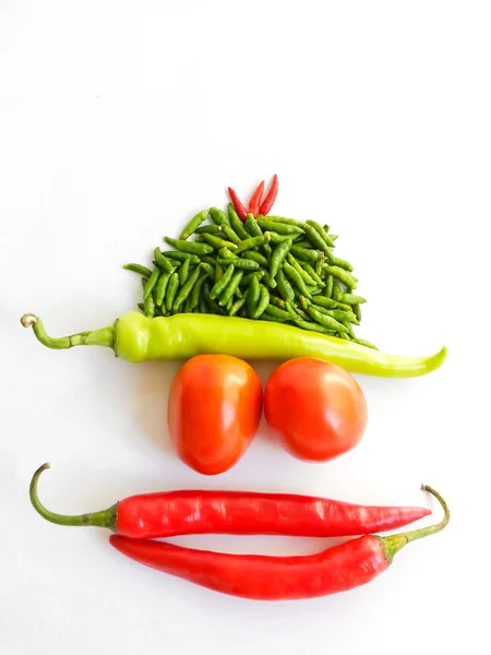 Tomate et piments formant à drôle visage — Photo