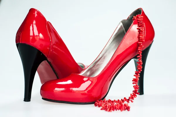 Zapatos rojos y collar aislado en blanco —  Fotos de Stock