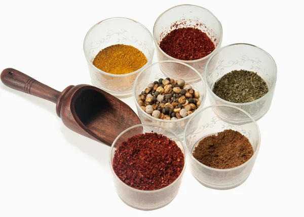 Spices and wood spoon on white — Stock Photo, Image