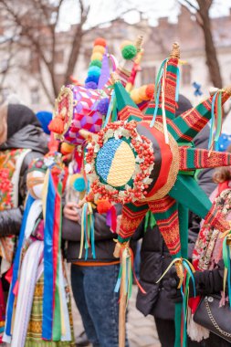 Different Christmas stars. The flash of Christmas star festival, traditional festival of handmade stars. Celebration of Orthodox Christmas in Lviv. Closeup view, selective focus. Vertical image