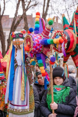 Lviv, Ukraine - January 8, 2022 : The flash of Christmas star festival, traditional festival of Christmas stars and motanka doll. Celebration of Orthodox Christmas in Lviv. Selective focus, vertical