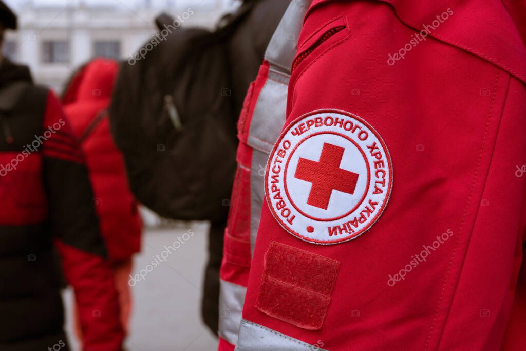 Lviv, Ukraine - March 8, 2022 : Red Cross mission help refugees during conflict in Ukraine - emblem in Ukrainian. Selective focus