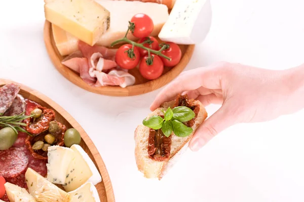 Top View Woman Hand Holding Bruschetta Sun Dried Tomatoes Table — Stock Photo, Image