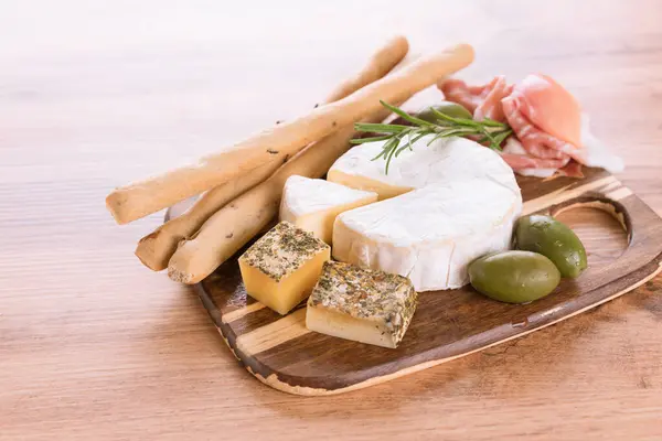 Solid Soft Ripened Cheeses Served Prosciutto Olives Grissini Bread Sticks — Stock Photo, Image