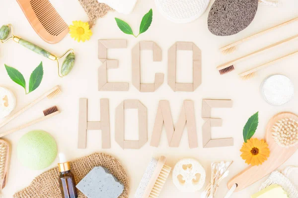 Natural bath accessories and self-care products for body care and home spa procedure over light yellow background with text ECO HOME. Zero waste concept. Flat lay style