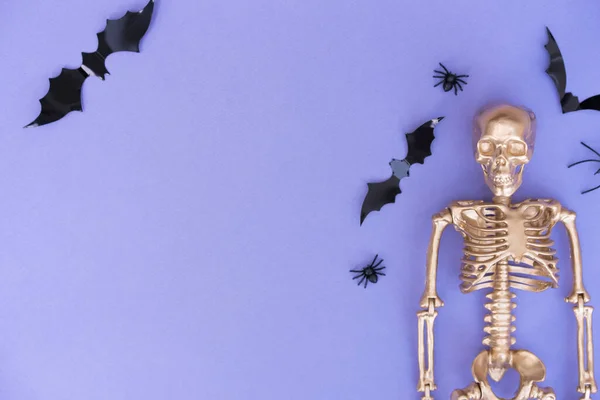 Trendy Halloween Background Golden Skeleton Bats Spiders Purple Background Copy — Zdjęcie stockowe