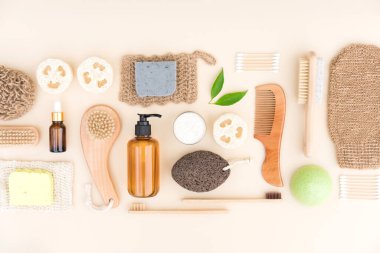 Flat lay composition with self-care products and herbal cosmetics for bodycare and skin care. Natural bath accessories bundle over light background. Eco living concept, home spa