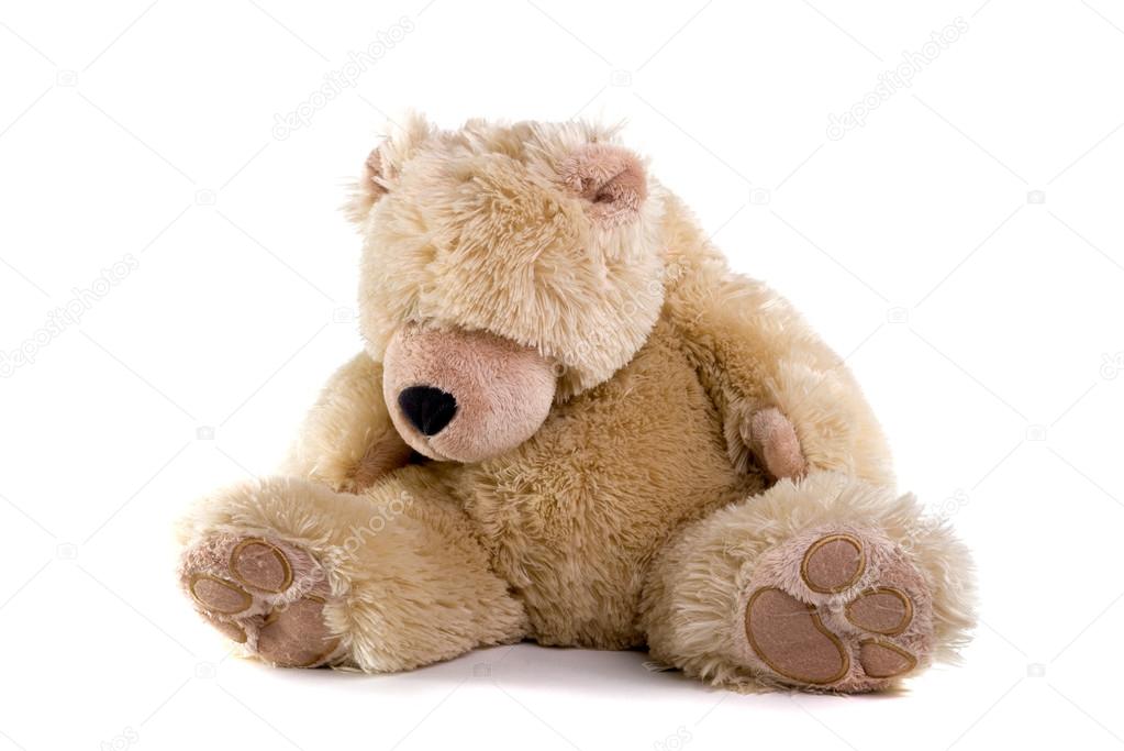 Sad teddy bear on white background