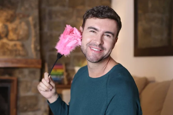 Close Portrait Handsome Young Man Holding Pink Feather Duster Home — Stockfoto