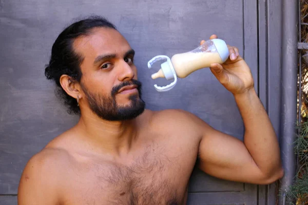 Close Portrait Handsome Shirtless Young Man Holding Baby Feeding Bottle — стоковое фото
