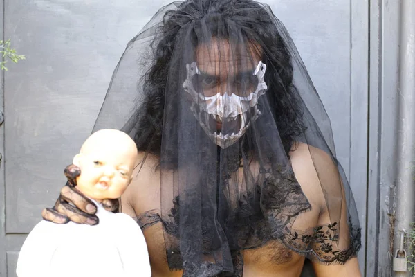 Close Portrait Shirtless Young Man Mask Black Veil Holding Doll — стоковое фото