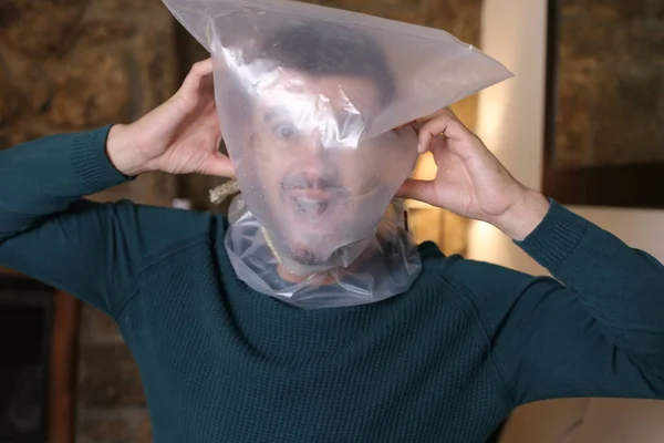 Close Portrait Scared Young Man Plastic Bag Head Home — Stok fotoğraf