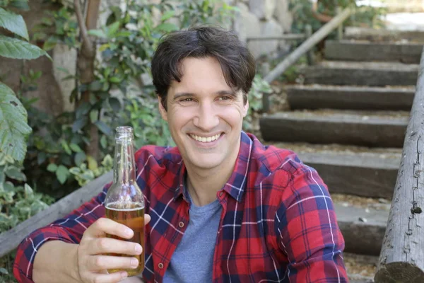 Elinde bira şişesi olan yakışıklı bir gencin portresi.