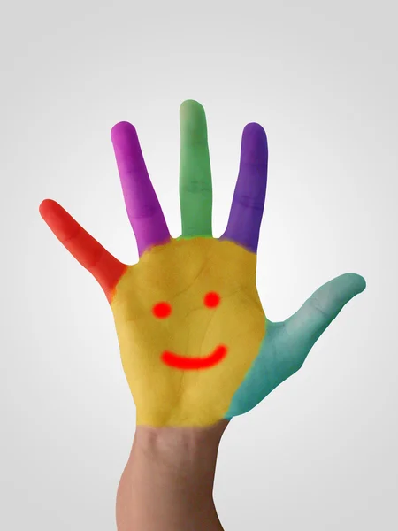 笑顔で着色された手のロゴとしてカラフルな塗料で塗装 — ストック写真