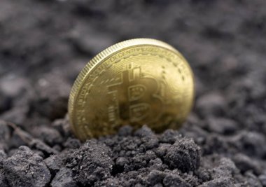 The concept of extraction and mining of cryptocurrency. Bitcoin dug up in the ground