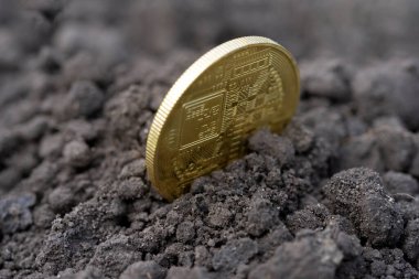 The concept of extraction and mining of cryptocurrency. Bitcoin dug up in the ground