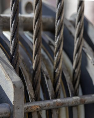 Unloading cargo and loading cargo with a crane. Crane boom and hook against the sky with engineering details and knots.