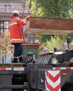 Unloading cargo and loading cargo with a crane. Crane boom and hook against the sky with engineering details and knots.