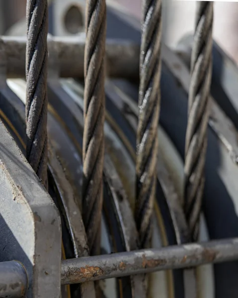 Unloading cargo and loading cargo with a crane. Crane boom and hook against the sky with engineering details and knots.